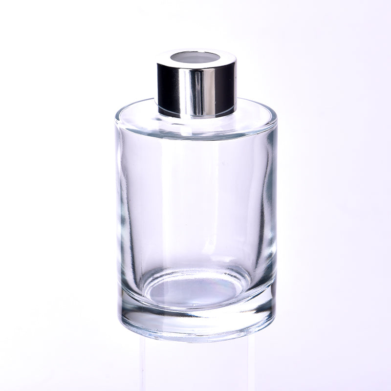 Round glass reed diffuser bottle with silver neck and plastic stopper